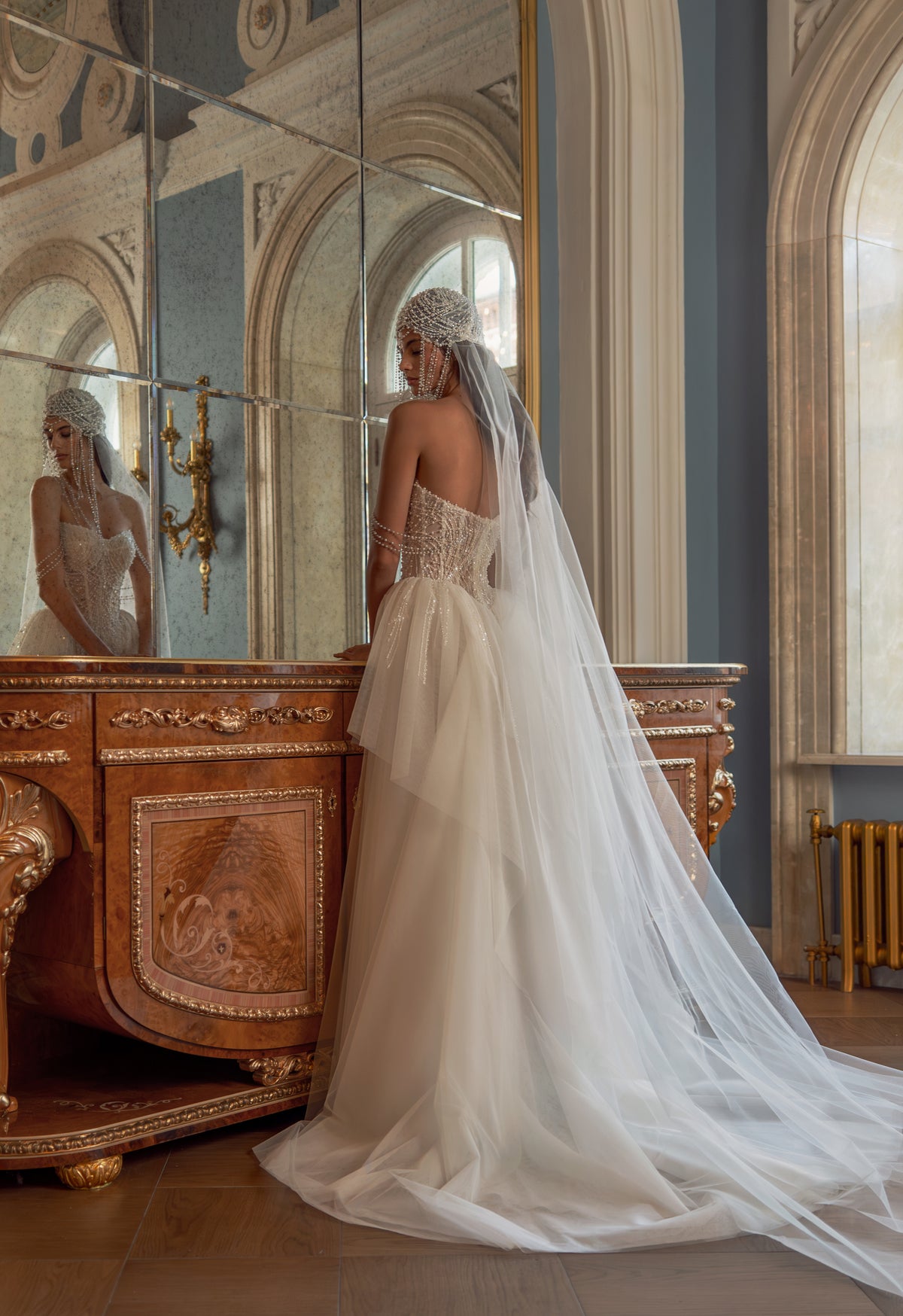 Beaded pearl corset wedding dress with veil – back view of the tulle skirt and long veil
