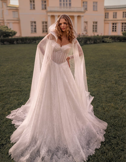 Romantic off-shoulder lace A-line wedding gown with long sleeves and corset bodice with cape