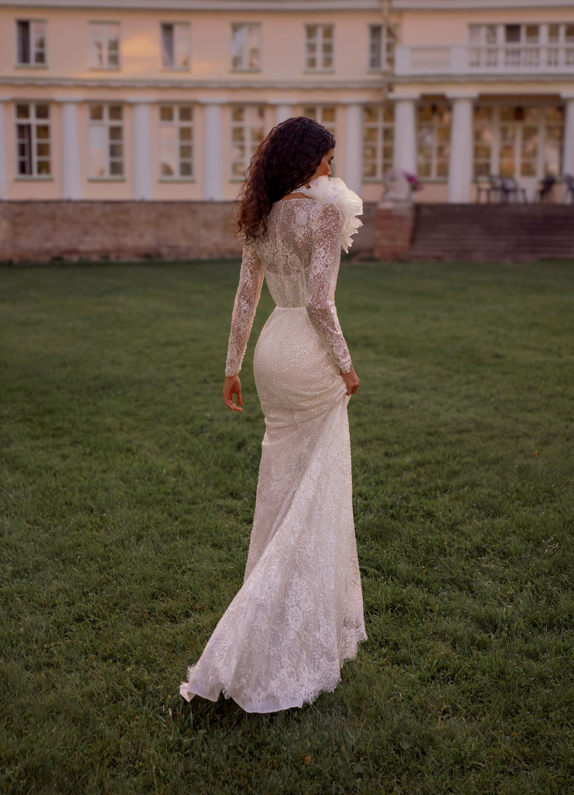 Bride wearing a sheath lace wedding dress with illusion neckline and detachable choker